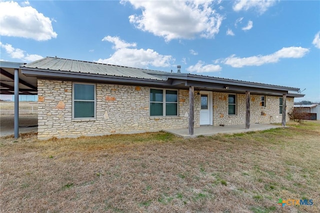 rear view of house with a patio area and a lawn