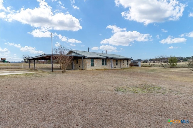 view of front of property with a rural view and a carport