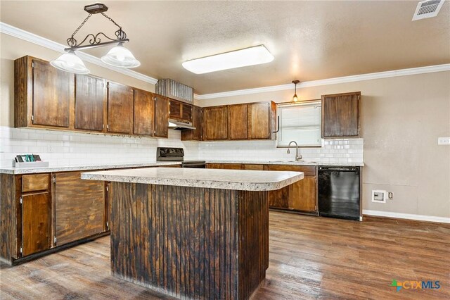 kitchen featuring hardwood / wood-style floors, decorative light fixtures, black appliances, and a kitchen island