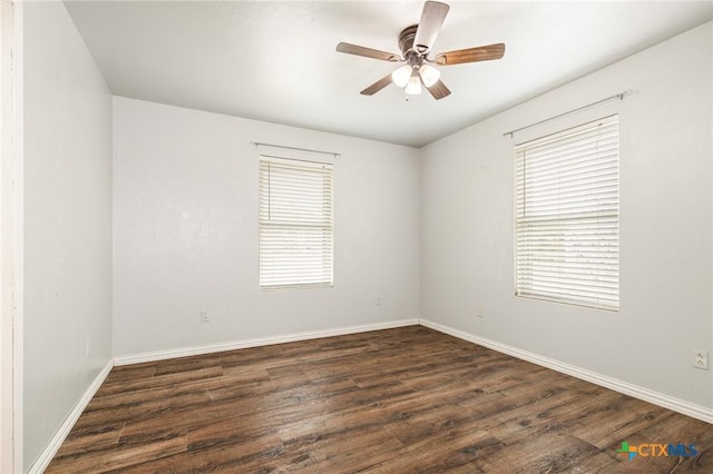 unfurnished room featuring ceiling fan and dark hardwood / wood-style flooring