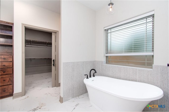 6864 Moffat Loop, Temple, TX 76502 - full bath featuring a freestanding bath, wainscoting, a walk in closet, and marble finish floor