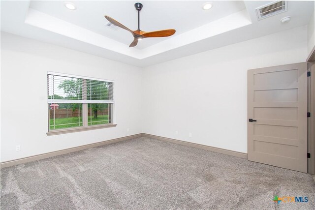 6864 Moffat Loop, Temple, TX 76502 - spare room featuring visible vents, a ceiling fan, carpet, and a tray ceiling