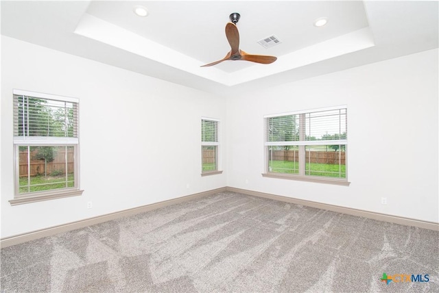 6864 Moffat Loop, Temple, TX 76502 - carpeted spare room featuring baseboards, ceiling fan, a tray ceiling, and visible vents