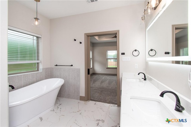 6864 Moffat Loop, Temple, TX 76502 - bathroom featuring a sink, double vanity, marble finish floor, visible vents, and a soaking tub