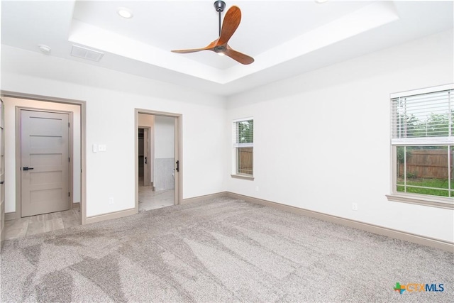 6864 Moffat Loop, Temple, TX 76502 - unfurnished bedroom with light colored carpet, a raised ceiling, recessed lighting, baseboards, and visible vents