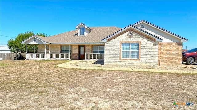 view of front of property with covered porch and a front yard