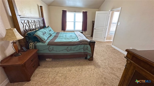 carpeted bedroom featuring lofted ceiling