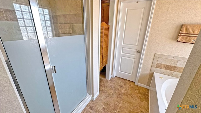 bathroom featuring shower with separate bathtub