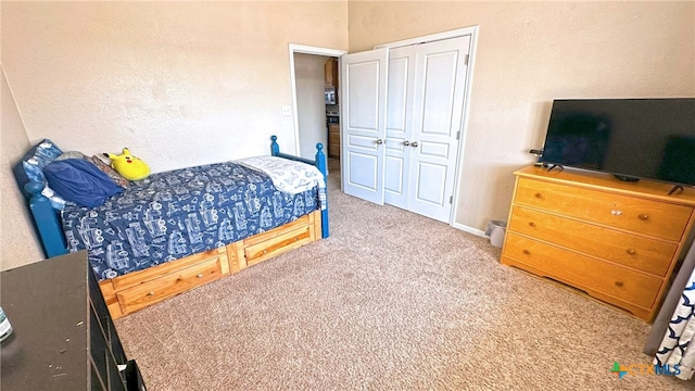 carpeted bedroom featuring a closet