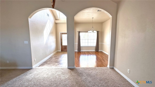 interior space with a chandelier and light carpet