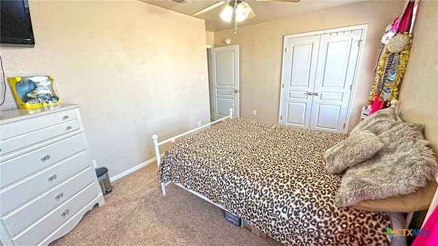 bedroom featuring light carpet, ceiling fan, and a closet