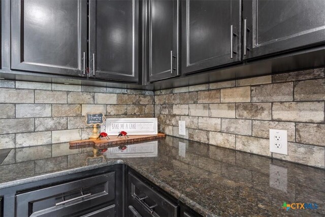 1606 Fiddle Wood Way, Temple, TX 76502 - kitchen featuring dark cabinets, dark stone counters, and decorative backsplash