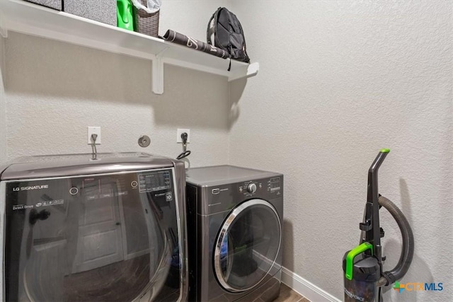 1606 Fiddle Wood Way, Temple, TX 76502 - washroom featuring separate washer and dryer and a textured wall