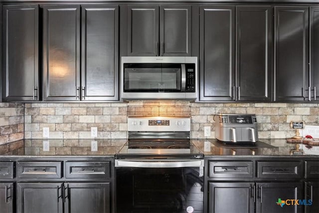 1606 Fiddle Wood Way, Temple, TX 76502 - kitchen with stainless steel appliances, dark cabinets, backsplash, and dark stone counters