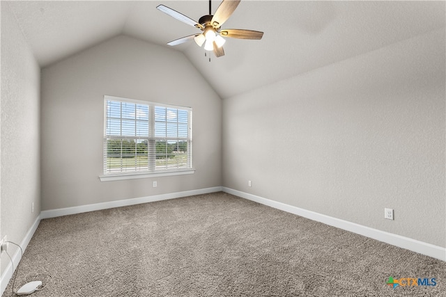 spare room with ceiling fan, carpet flooring, and lofted ceiling