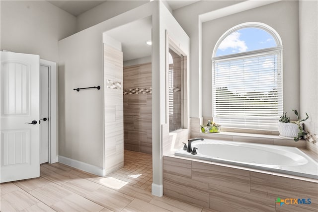 bathroom with shower with separate bathtub