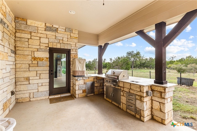 view of patio with an outdoor kitchen and area for grilling