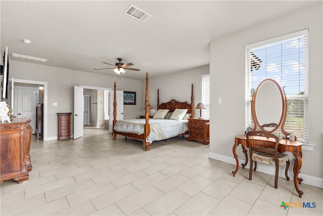 tiled bedroom featuring ceiling fan