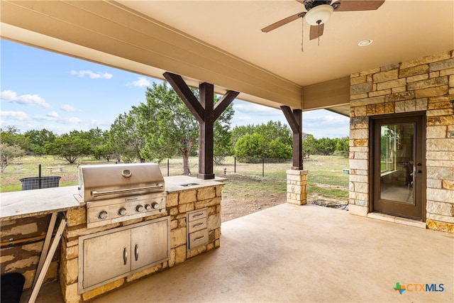 view of patio / terrace featuring an outdoor kitchen, a grill, and ceiling fan