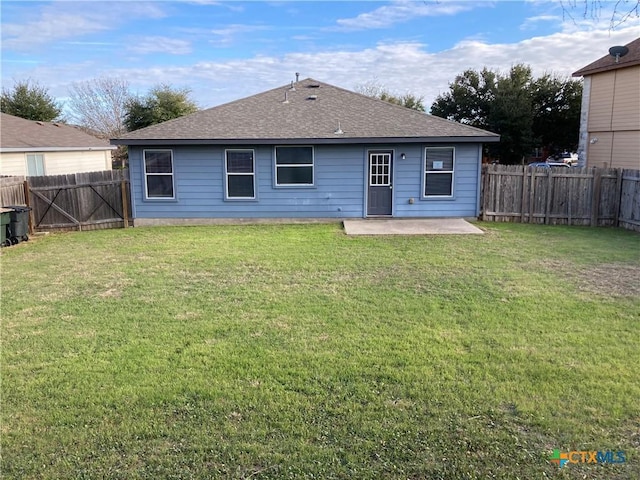 back of house featuring a patio area and a yard