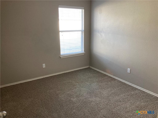 carpeted empty room with a healthy amount of sunlight