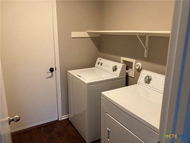 washroom with washer and clothes dryer and dark hardwood / wood-style floors