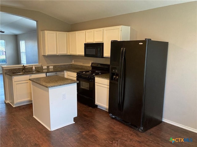 kitchen with a center island, white cabinets, black appliances, and sink