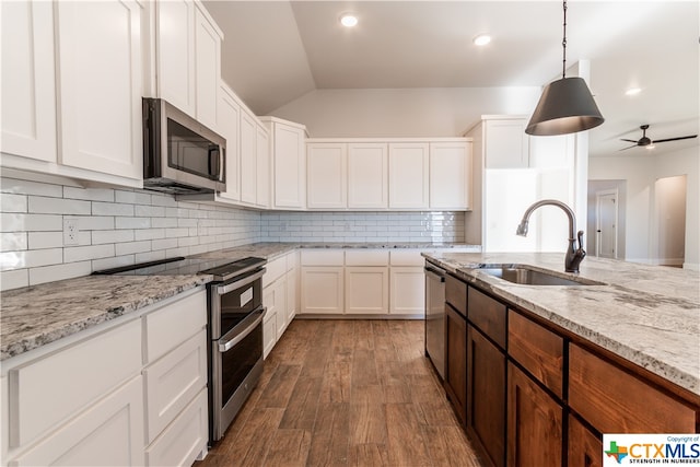 kitchen with white cabinetry, appliances with stainless steel finishes, and dark hardwood / wood-style flooring