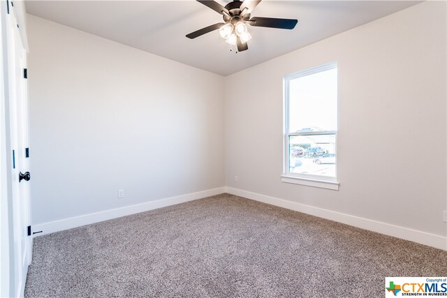 empty room featuring carpet and ceiling fan