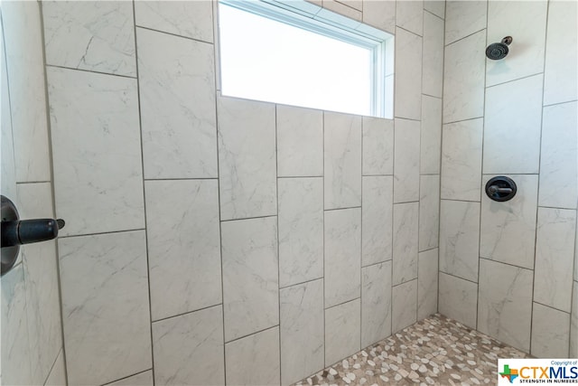 bathroom with tiled shower