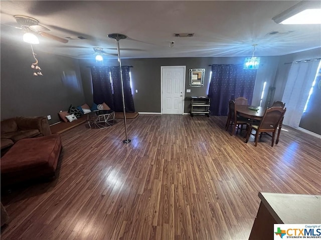 living room featuring hardwood / wood-style floors and ceiling fan