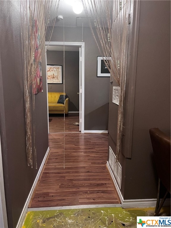 hallway with dark hardwood / wood-style flooring