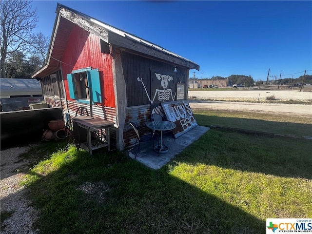 view of side of home with a yard