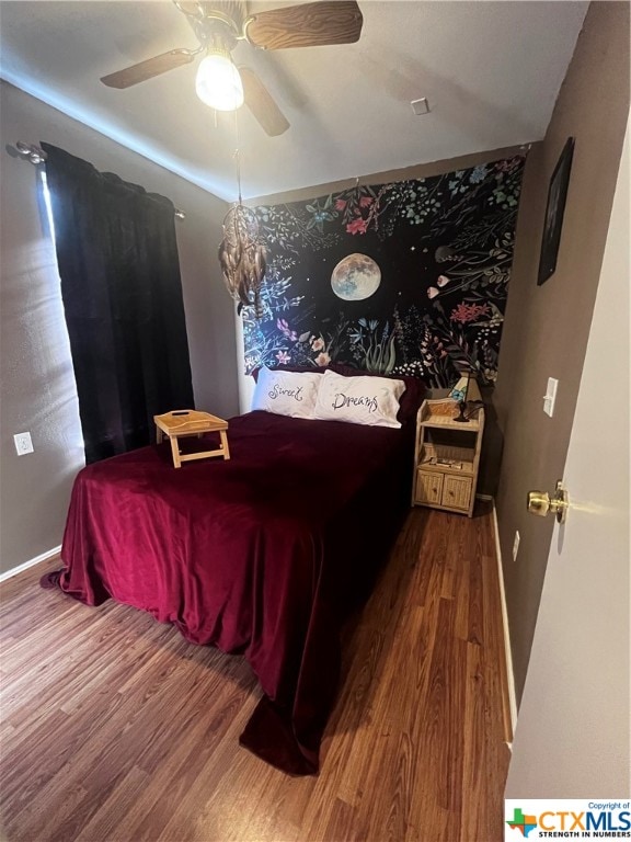 bedroom with hardwood / wood-style floors and ceiling fan