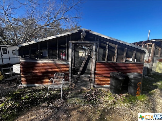 rear view of house with a sunroom