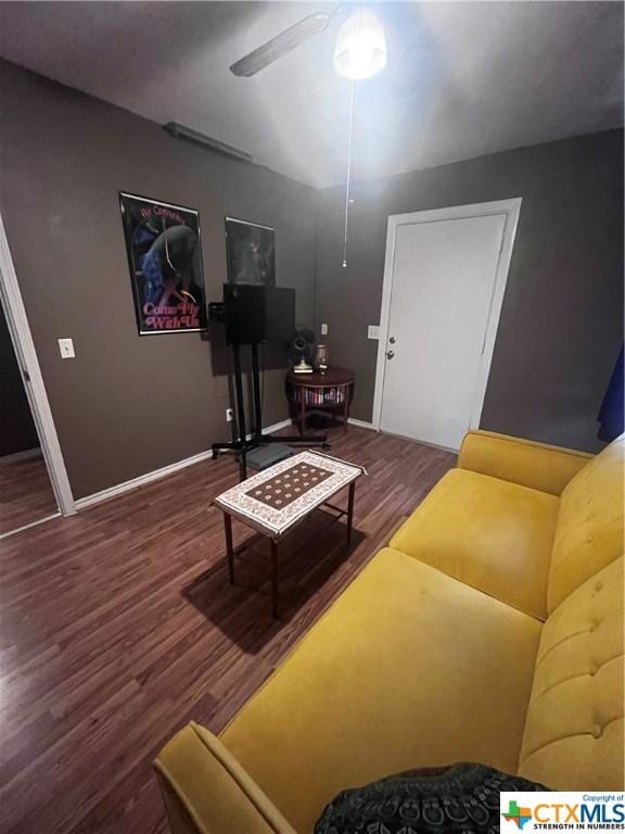 living room featuring wood finished floors, a ceiling fan, and baseboards