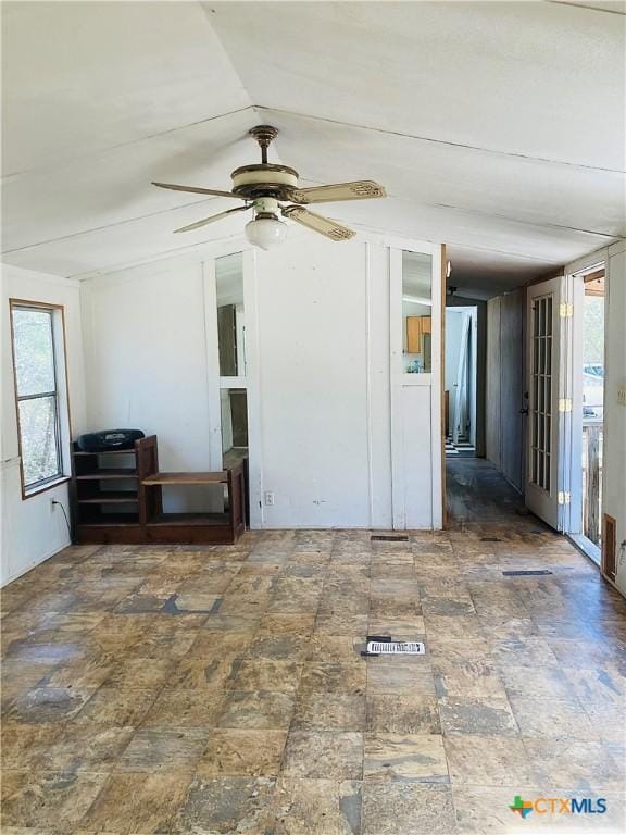 empty room with a ceiling fan and french doors