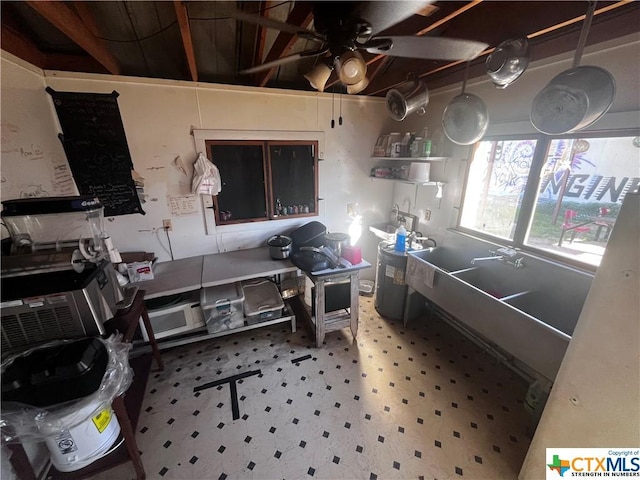kitchen with a ceiling fan and tile patterned floors
