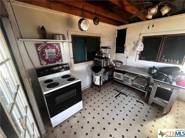 kitchen featuring ceiling fan and electric range oven