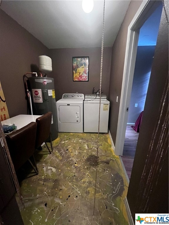 laundry area featuring water heater, hardwood / wood-style floors, and independent washer and dryer