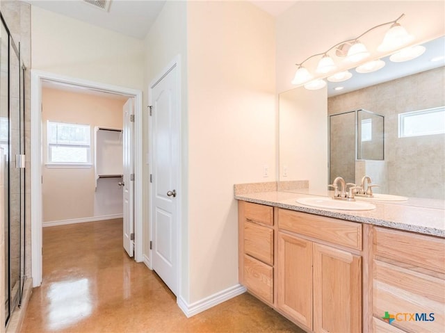 207 Yale St, San Marcos, TX 78666 - full bathroom featuring a tile shower, healthy amount of natural light, concrete floors, and a spacious closet