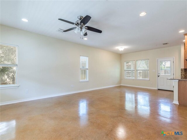 207 Yale St, San Marcos, TX 78666 - spare room with baseboards, finished concrete flooring, a ceiling fan, and recessed lighting