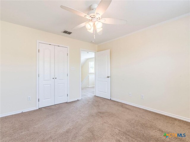 207 Yale St, San Marcos, TX 78666 - unfurnished bedroom with carpet, baseboards, a closet, and ceiling fan