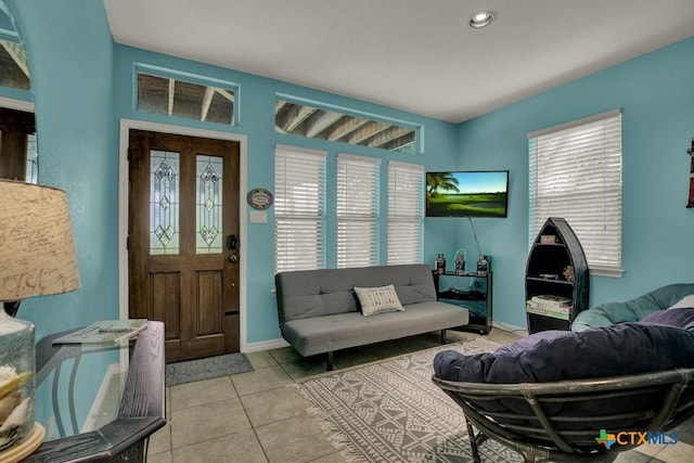 living room featuring recessed lighting, baseboards, and light tile patterned floors