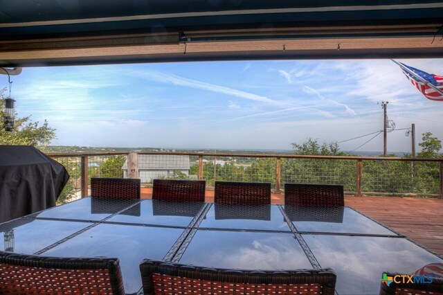 view of patio / terrace featuring grilling area, a wooden deck, and outdoor dining area