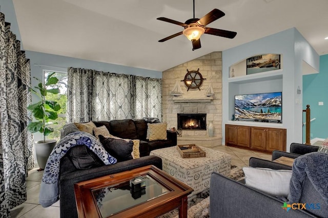 living area featuring light tile patterned flooring, lofted ceiling, a fireplace, and ceiling fan
