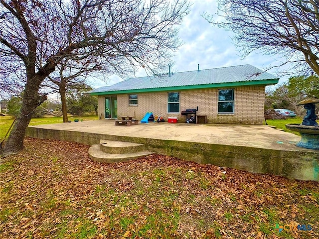 back of property with a patio