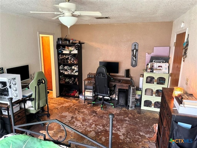 office area featuring ceiling fan and a textured ceiling