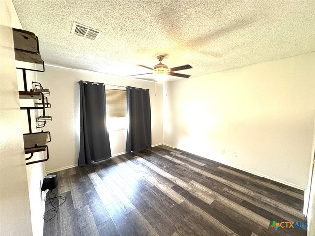 13722 Earlywood St, San Antonio, TX 78233 - unfurnished bedroom with dark wood-style flooring, a textured ceiling, ceiling fan, and baseboards