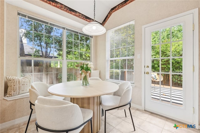 sunroom with vaulted ceiling, plenty of natural light, and french doors